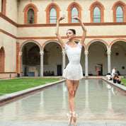 Dance leotard with deep boat neckline. Ballerina en pointe in front of a castle.