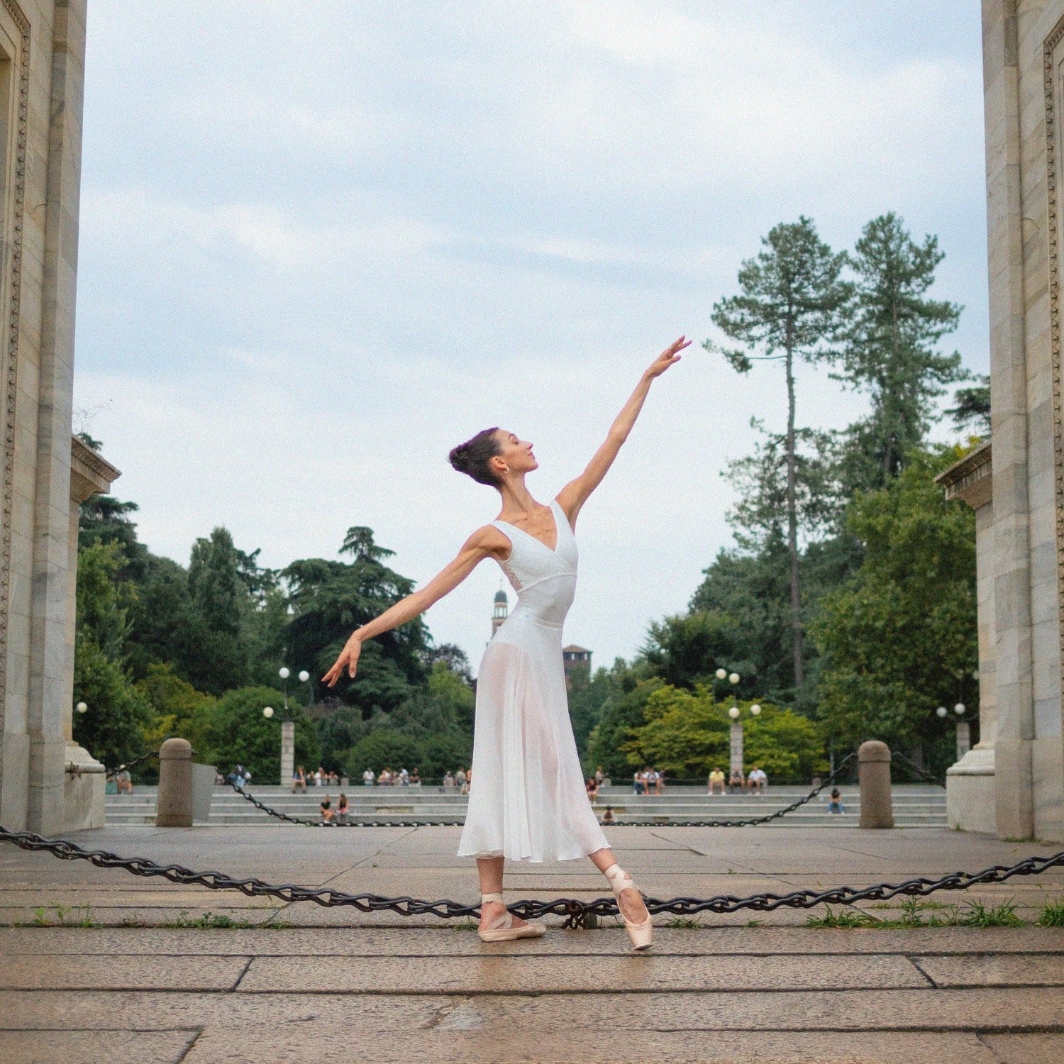 Ballerina en-dehor wearing a white crossed leotard